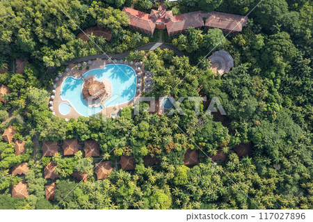 Tropical landscape with villa roofs and blue pool Tropical landscape with villa roofs and blue pool 117027896