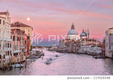 Pink sunset sky over the Grand Canal in Venice at sunset. Pink sunset sky over the Grand Canal in Venice at sunset. 117028346