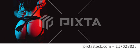 dominant man with whip flogger slaps the sexy ass of a submissive bottom woman slave girl. BDSM sex with submission and domination between couple. Wide banner with black background dominant man with whip flogger slaps the sexy ass of a submissive bottom woman slave girl. BDSM sex with submission and domination between couple. Wide banner with black background 117028825