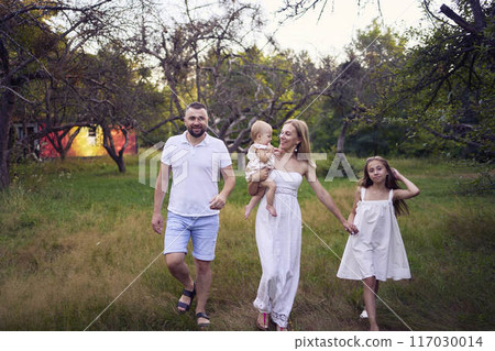 family of four on a walk in the park 117030014