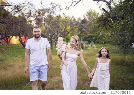 family of four on a walk in the park family of four on a walk in the park 117030015