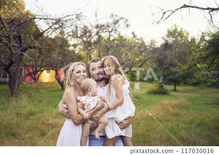 family of four on a walk in the park 117030016