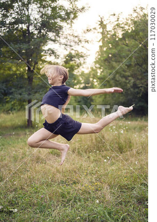 A 10-year-old gymnast practices in the garden 117030029