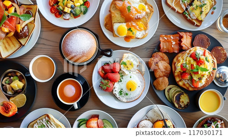 brunch dishes displayed on a table, featuring eggs, toast, fresh fruits, pancakes, pastries 117030171