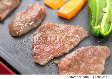 Grilling yakiniku (beef skirt steak) on a hot plate Grilling yakiniku (beef skirt steak) on a hot plate 117030416