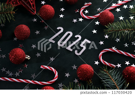 New Year 2025 dark background. Number of the coming year in Christmas decoration. 117030420