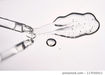 Pipette with cosmetic gel or serum close-up. 117030421