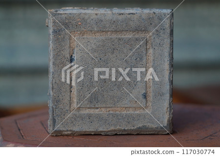 Square paving slabs stand on the side. Building materials for landscaping, improvement of living spaces in the urban environment Square paving slabs stand on the side. Building materials for landscaping, improvement of living spaces in the urban environment 117030774