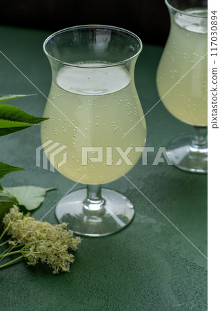 Carbonated elderflower drink. Flower summer kvass in glasses 117030894