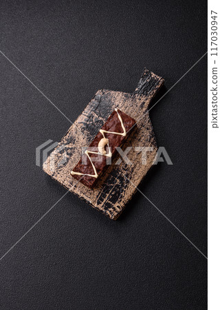 Delicious sweet brownies with chocolate and nuts Delicious sweet brownies with chocolate and nuts 117030947