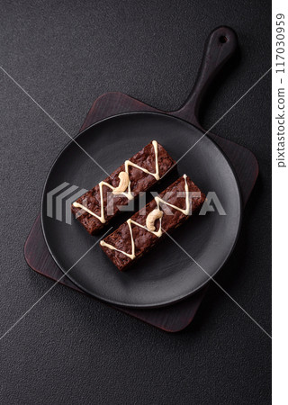 Delicious sweet brownies with chocolate and nuts Delicious sweet brownies with chocolate and nuts 117030959