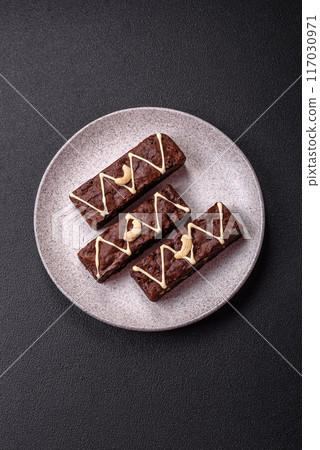Delicious sweet brownies with chocolate and nuts Delicious sweet brownies with chocolate and nuts 117030971