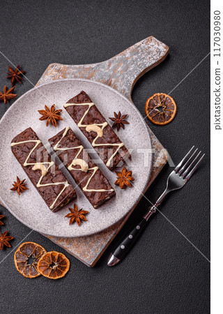 Delicious sweet brownies with chocolate and nuts Delicious sweet brownies with chocolate and nuts 117030980