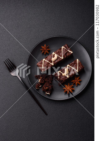 Delicious sweet brownies with chocolate and nuts Delicious sweet brownies with chocolate and nuts 117030982