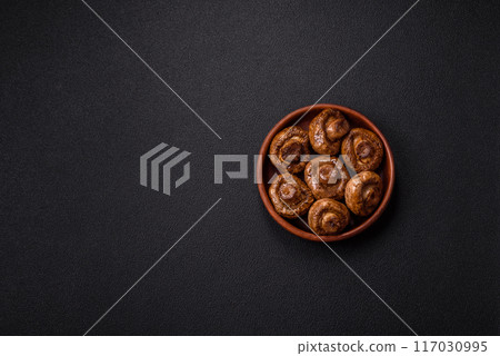 Delicious juicy whole champignons baked on the grill with salt and spices Delicious juicy whole champignons baked on the grill with salt and spices 117030995