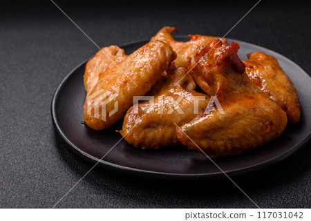 Delicious fried chicken wings with salt, spices and herbs Delicious fried chicken wings with salt, spices and herbs 117031042