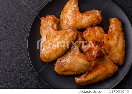 Delicious fried chicken wings with salt, spices and herbs 117031043