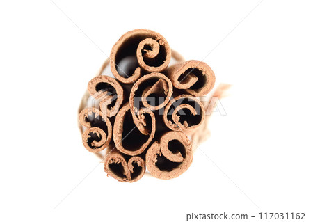 Top view of several tied cassia spice sticks on white background. Top view of several tied cassia spice sticks on white background. 117031162