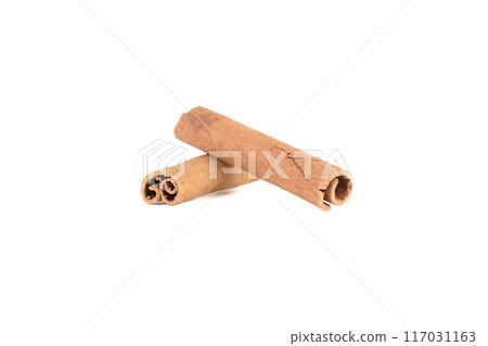 Two aromatic sticks of cassia spice on white background. Two aromatic sticks of cassia spice on white background. 117031163