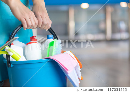 Professional cleaner with a bucket of cleaning products. 117031233