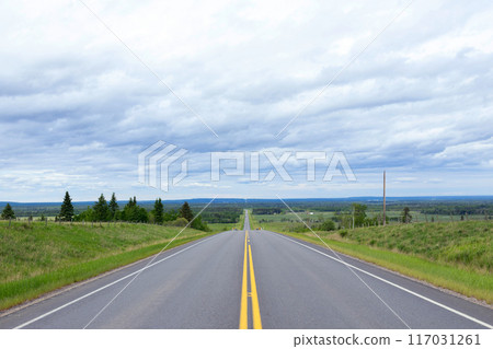 Scenic view from the highway with yellow solid lines in plains. Scenic view from the highway with yellow solid lines in plains. 117031261
