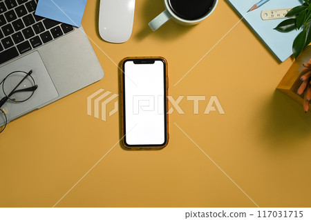 Smartphone with blank screen, laptop, coffee cup and glasses on yellow background 117031715