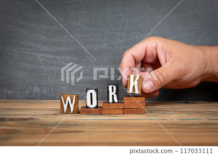 WORK. Wooden letters, alphabet blocks on steps. development and growth concept 117033111