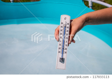 The thermometer shows 45 degrees in the heat wave, edge of the garden pool in the background The thermometer shows 45 degrees in the heat wave, edge of the garden pool in the background 117033113
