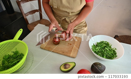 Housewife woman chef in kitchen apron cooking, preparing Italian meal in the home kitchen 117033193