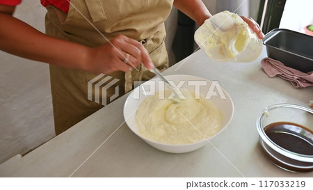 Housewife woman chef in kitchen apron cooking, preparing Italian meal in the home kitchen Housewife woman chef in kitchen apron cooking, preparing Italian meal in the home kitchen 117033219