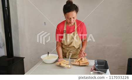 Housewife woman chef in kitchen apron cooking, preparing Italian meal in the home kitchen 117033226