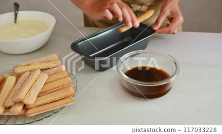 Housewife woman chef in kitchen apron cooking, preparing Italian meal in the home kitchen 117033228