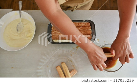 Housewife woman chef in kitchen apron cooking, preparing Italian meal in the home kitchen 117033239