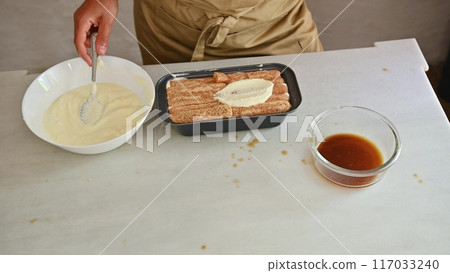 Housewife woman chef in kitchen apron cooking, preparing Italian meal in the home kitchen 117033240