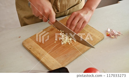 Housewife woman chef in kitchen apron cooking, preparing Italian meal in the home kitchen 117033273