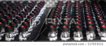 HPLC glass vials with black caps in the auto sampler are waiting for injection. HPLC glass vials with black caps in the auto sampler are waiting for injection. 117033531