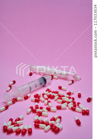 Medications on a pink table. Medications on a pink table. 117033634
