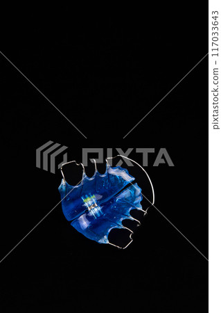 Orthodontic appliance on black background 117033643