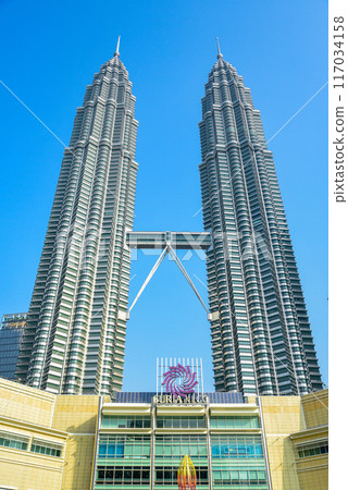 A beautiful view of the Petronas Twin Towers in Kuala Lumpur against the blue sky A beautiful view of the Petronas Twin Towers in Kuala Lumpur against the blue sky 117034158