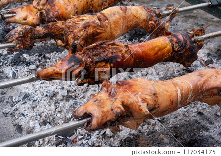 A pig grilled traditional coal and fire.  117034175