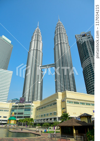 A beautiful view of the Petronas Twin Towers in Kuala Lumpur against the blue sky A beautiful view of the Petronas Twin Towers in Kuala Lumpur against the blue sky 117034215