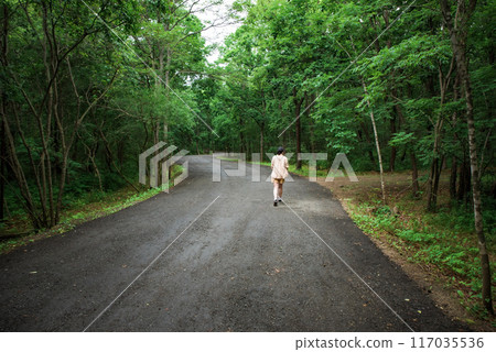Woman traveler far away walking in the forest Woman traveler far away walking in the forest 117035536