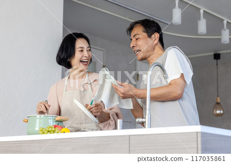 Middle couple standing in the kitchen Middle couple standing in the kitchen 117035861