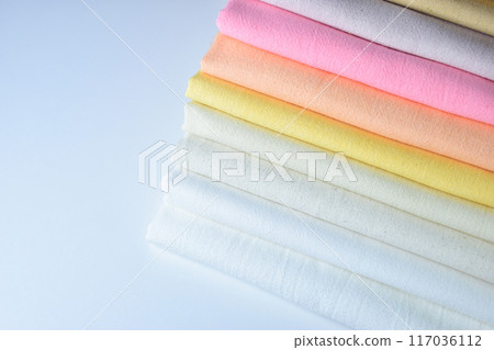 stack of colourful cotton clothes, pile of clothing on white background stack of colourful cotton clothes, pile of clothing on white background 117036112