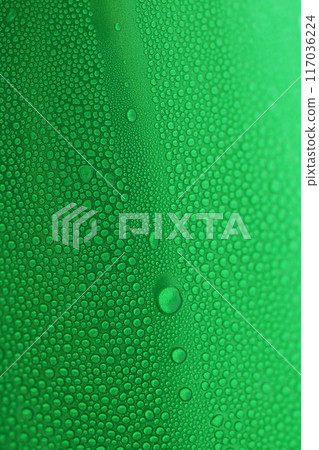 water drop on green beverage cans background, texture of cold aluminium drink package 117036224