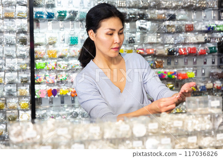 Female choosing bijouterie in jewelry store Female choosing bijouterie in jewelry store 117036826