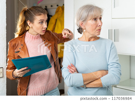 Young woman landlord and senior woman tenant discussing problem 117036984