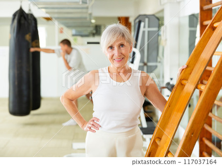 Positive mature woman in gym 117037164