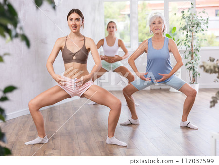 Young woman dancing in group in studio 117037599