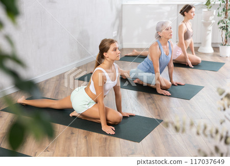 Womens different ages practicing yoga lesson at sport club 117037649